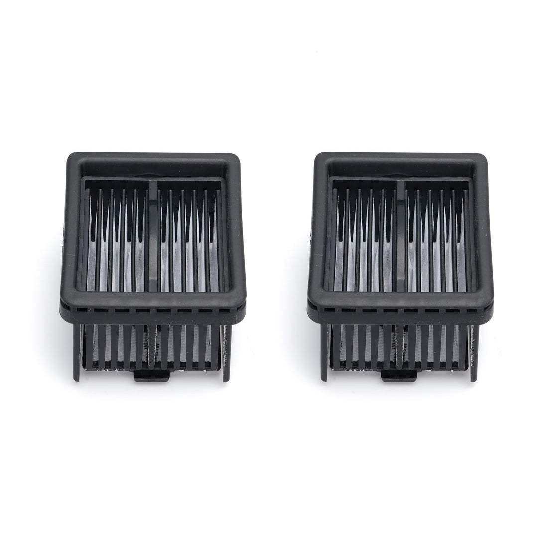 Two black plastic components with slotted design on a white background