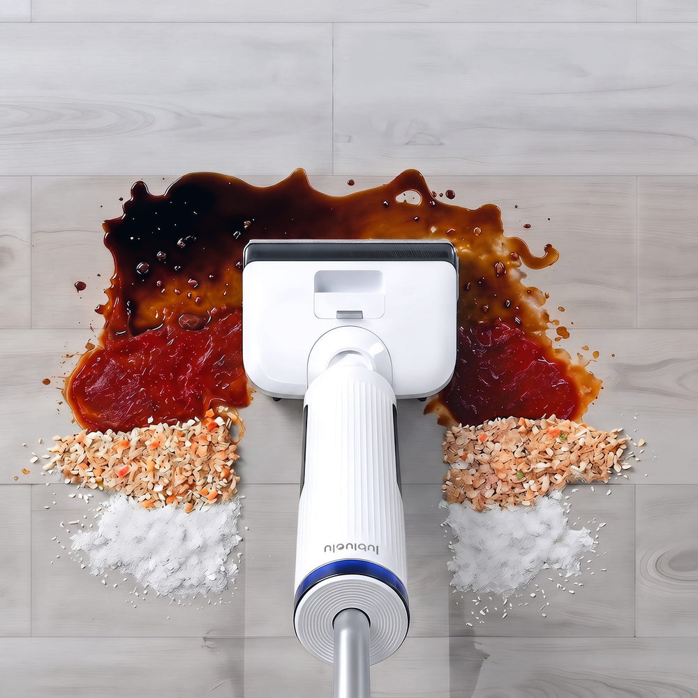 A handheld steam mop head pressed down onto a spilled drink and food mess on a light wood floor, with the mop handle centered above the stain.