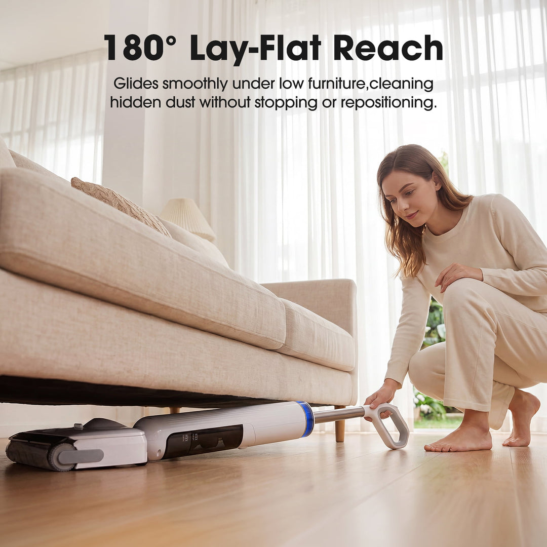 Woman using a vacuum cleaner with '180¡ã Lay-Flat Reach' feature under a couch.