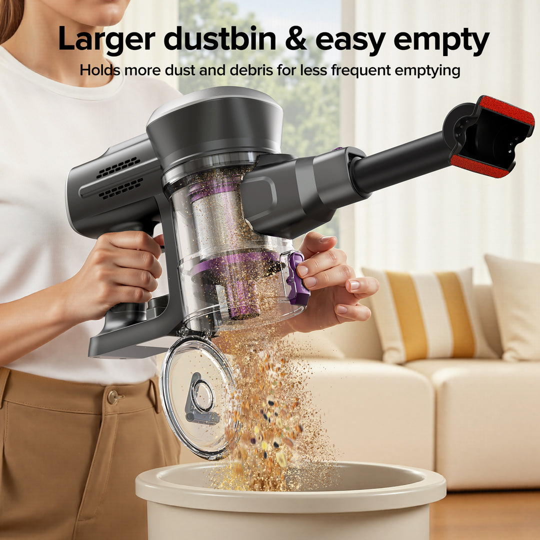 Person using a handheld vacuum cleaner to empty debris into a trash bin in a living room.