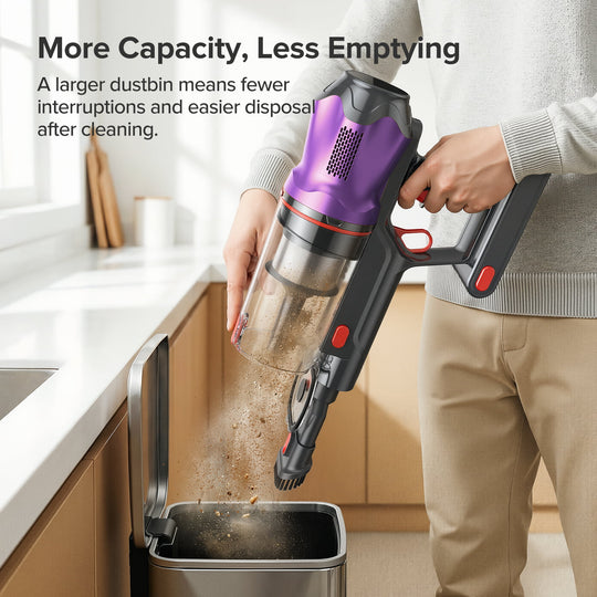 Person using a handheld vacuum cleaner to empty its dustbin into a trash can in a kitchen.