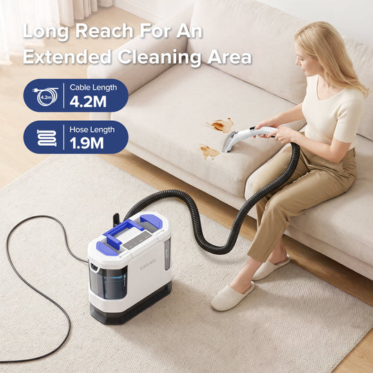 A woman sits on a beige sofa using a cordless vacuum cleaner with a long black hose on a light rug. The vacuum is white and blue, and the image includes text highlighting its long reach and cable/hose lengths.